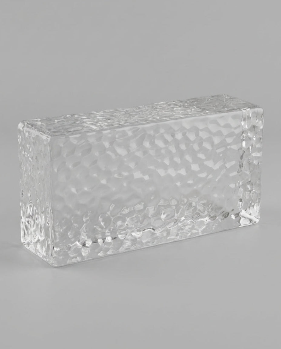 Clear rectangular crystal block on a gray background