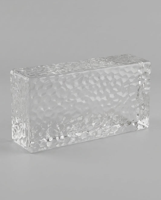 Clear rectangular crystal block on a gray background