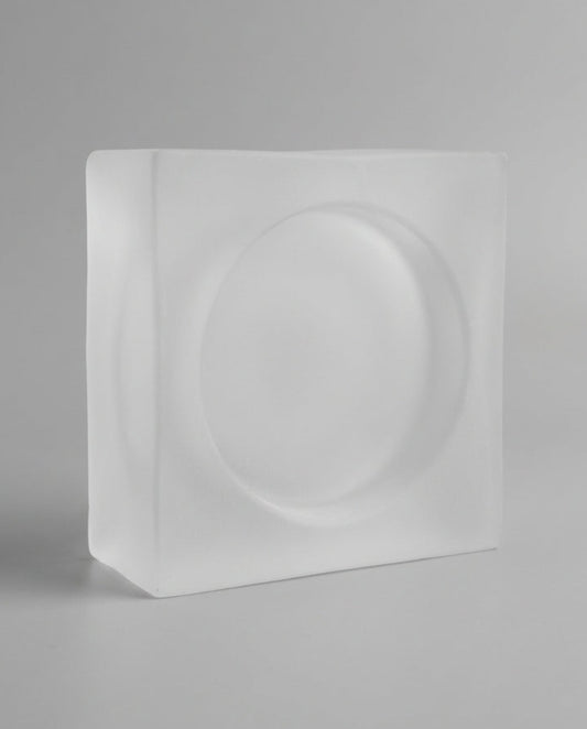 White rectangular block with circular design on a gray background