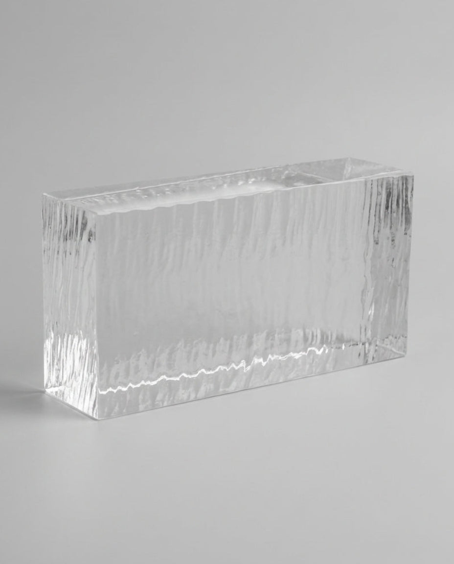 Clear rectangular glass vase on a gray background