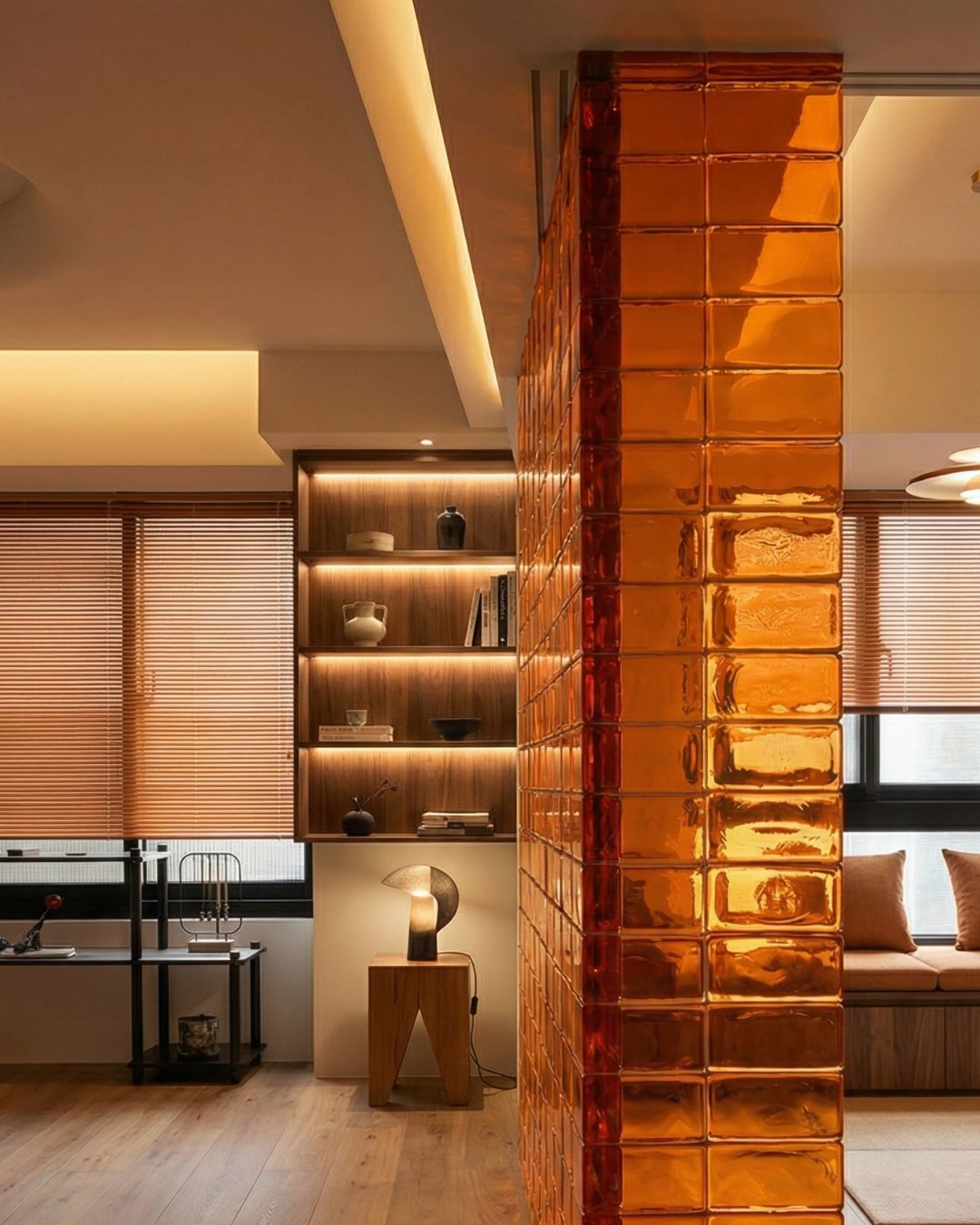 Green glass brick curved feature wall in modern commercial lobby with bench seating
