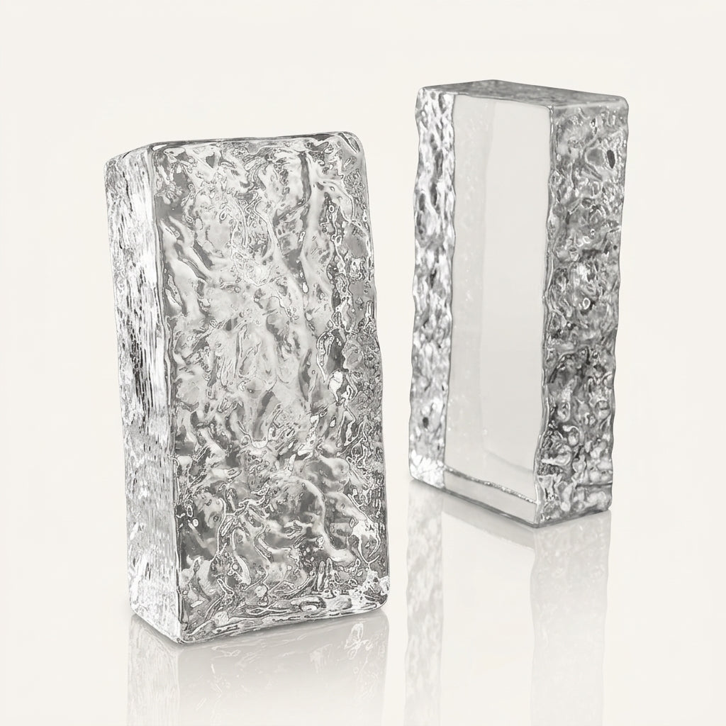 Two clear solid glass bricks with ice texture standing upright on dark reflective surface